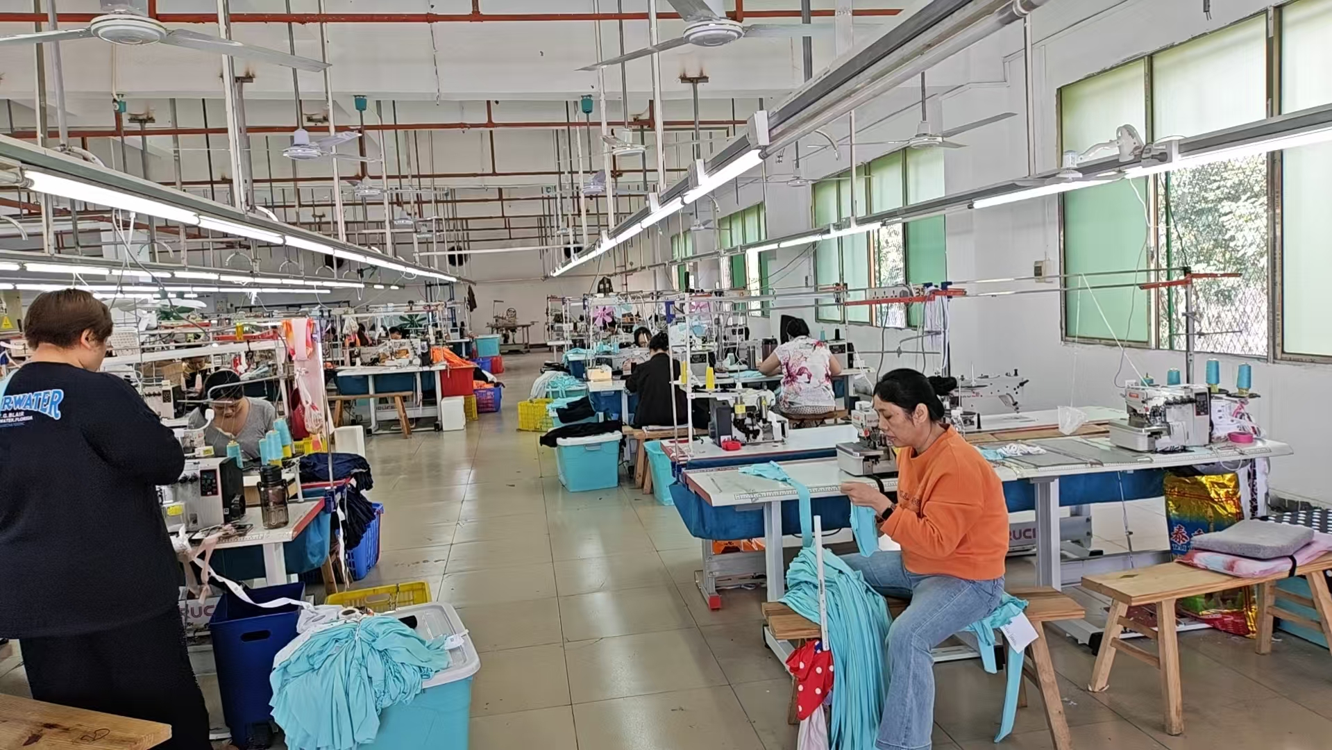 Sewing workstations and garment production inside the YATAI CLOTHING workshop.